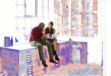 Two employees talking to each other surrounded by graphics representing data