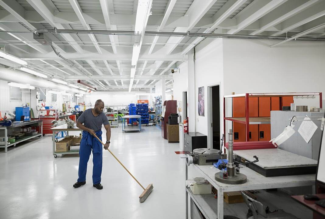 Man sweeping factory floor